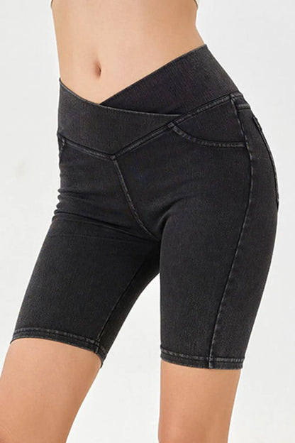 Peacock blue Basic Bae asymmetrical waist denim shorts by Trendsi with front pockets and distressed hem, casual summer style.