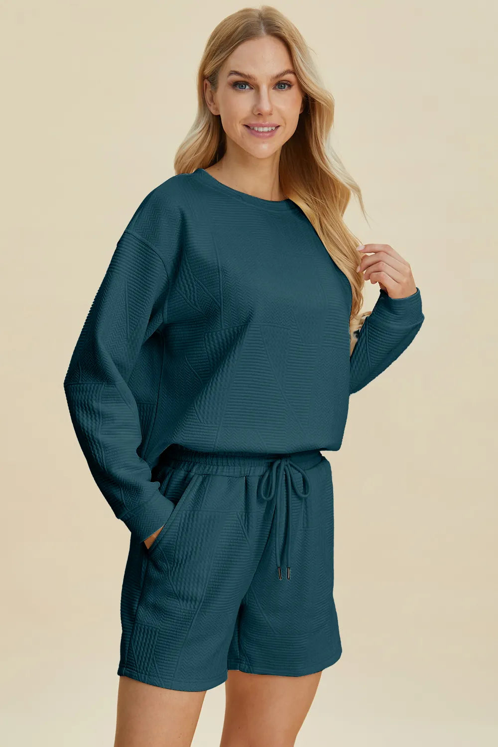 Peacock blue Trendsi Double Take full size texture round neck long sleeve top and matching shorts set, casual and comfortable.