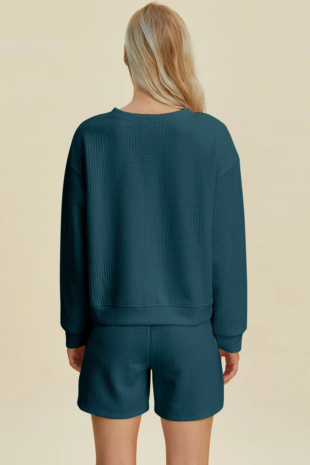 Peacock blue Trendsi Double Take full size textured round neck long sleeve top and matching shorts set on a model.