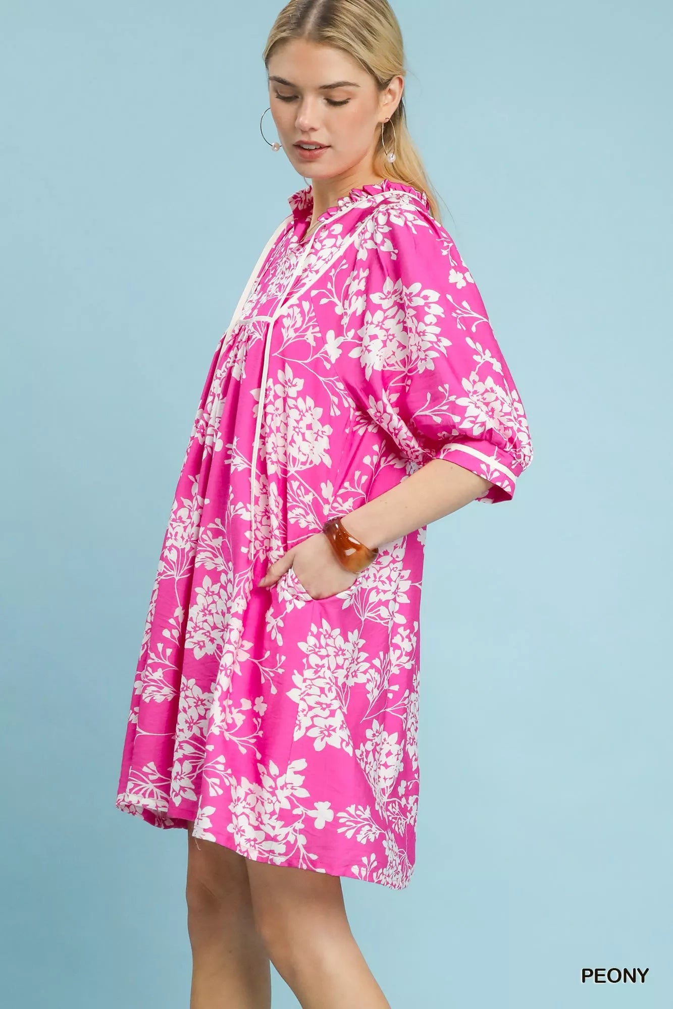 Umgee floral babydoll dress with pockets, featuring a flowy design and vibrant floral pattern, perfect for casual or summer wear.