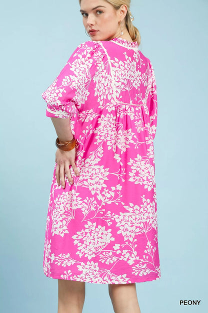 Trendsi Umgee floral babydoll dress with pockets, featuring a flowy silhouette and vibrant flower print on lightweight fabric.