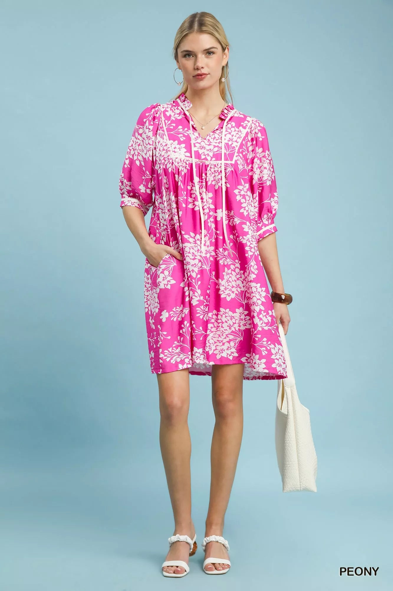 Trendsi Umgee floral babydoll dress with short sleeves, pockets, and a flowy fit, featuring a colorful peony print.
