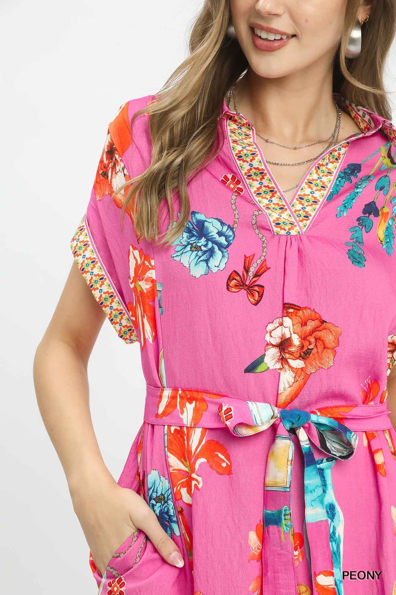 Umgee floral print mini dress with belt featuring a vibrant pattern and stylish waist tie, perfect for casual or summer wear.
