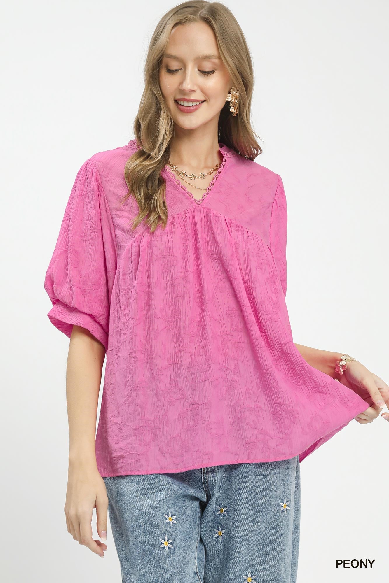 Textured lace trim boho blouse by Umgee featuring a V-neck and relaxed fit, styled with long sleeves and a casual, trendy look.