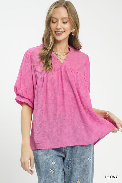 Textured lace trim boho blouse by Umgee featuring a V-neck and relaxed fit, styled with long sleeves and a casual, trendy look.