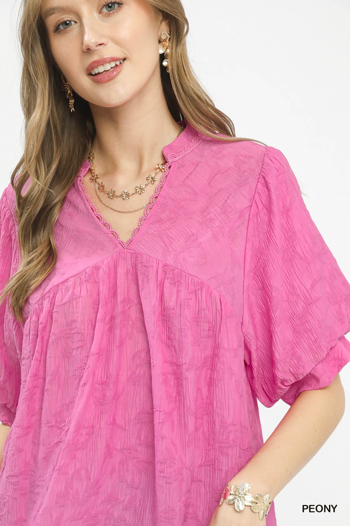 Umgee textured lace trim V-neck boho blouse with long sleeves and relaxed fit, styled with casual accessories.