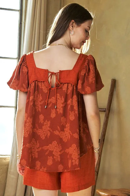 Davi & Dani nature printed square neck puff sleeve blouse featuring long sleeves and a relaxed fit, in a warm persimmon color.