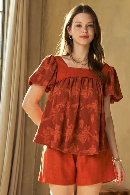 Davi & Dani Nature Printed Square Neck Puff Sleeve Blouse in persimmon, featuring floral print and billowy sleeves, on a mannequin.