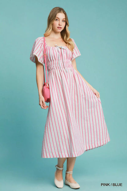 Pink and blue striped Umgee smocked short sleeve midi dress with a relaxed fit, perfect for casual summer wear.