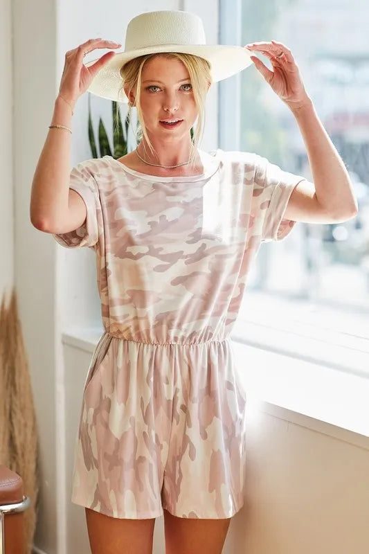 Pink camo print French terry romper with side pockets, trendy BiBi Camo style by Trendsi, casual and comfortable for everyday wear.