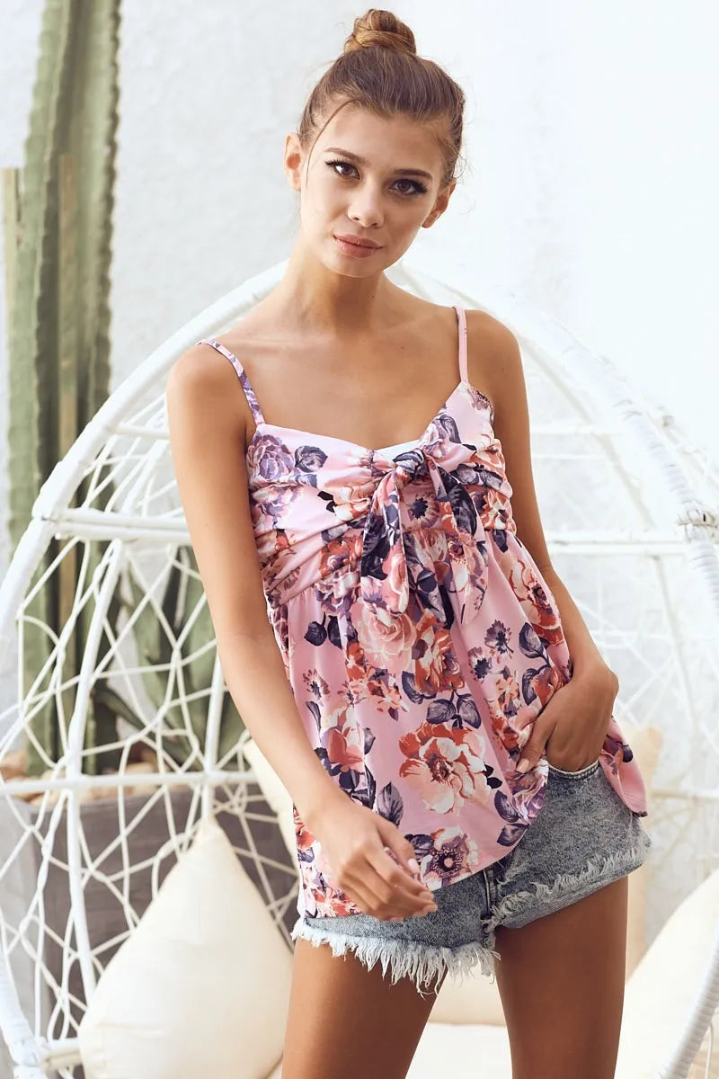 Pink floral printed jersey knit top with tie ribbon front from Trendsi, featuring a soft, comfortable fabric and stylish design.