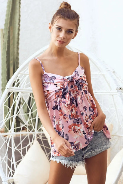 Pink floral printed jersey knit top with tie ribbon front from Trendsi, featuring a soft, comfortable fabric and stylish design.