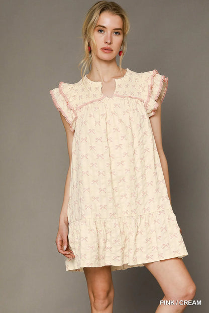 Pink and cream bow print mini dress by Umgee featuring ruffled cap sleeves and a flattering fit.