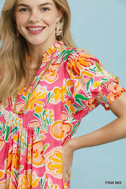 Pink floral print Umgee puff sleeve tiered midi dress with a feminine silhouette and ruffled details.