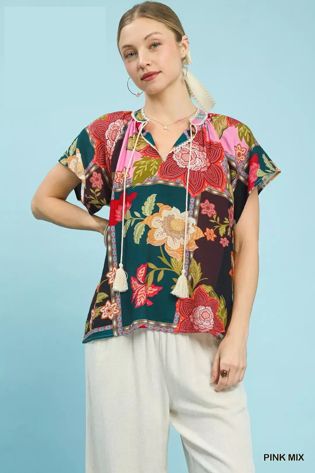 Pink floral patchwork tassel tie top by Umgee, featuring mixed patterns and a stylish tie detail, perfect for casual wear.