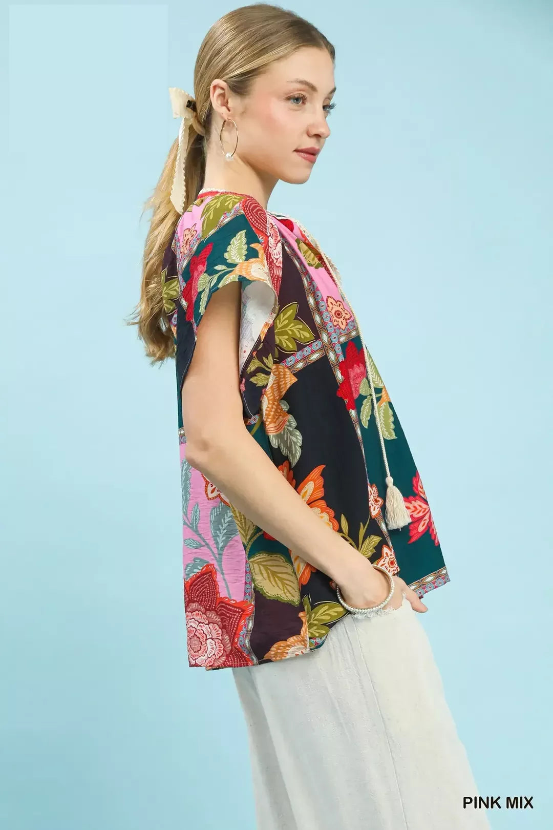 Pink floral patchwork tassel tie top by Umgee, featuring mixed floral patterns and a stylish tassel detail for a casual look.