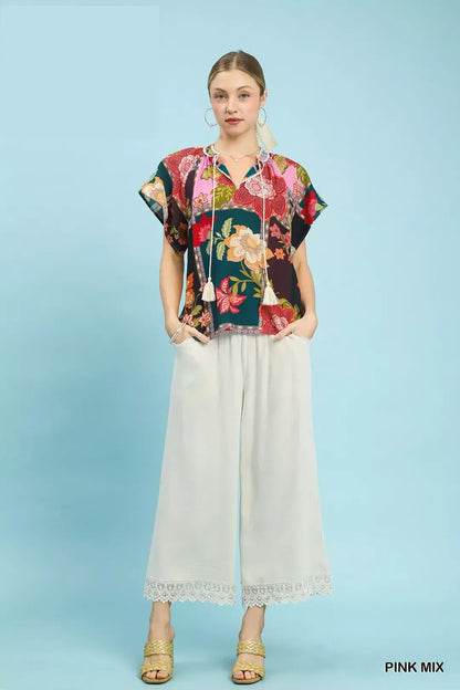 Pink floral patchwork tassel tie top by Umgee featuring a casual, boho-inspired design with colorful floral patterns and tassel details.