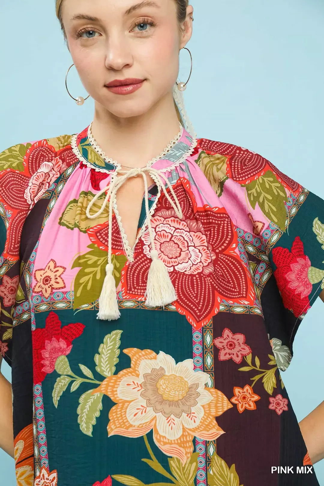 Pink Umgee Mix Floral Patchwork Tassel Tie Top featuring a boho style with floral patterns and tassel details.