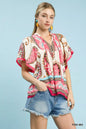 Pink Umgee tassel top with paisley border print and mixed patterns, featuring a relaxed fit and tassel details.
