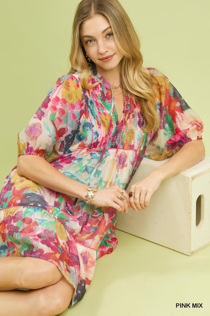 Pink watercolor floral babydoll dress by Umgee featuring a flowy silhouette and soft fabric, perfect for casual or dressy occasions.