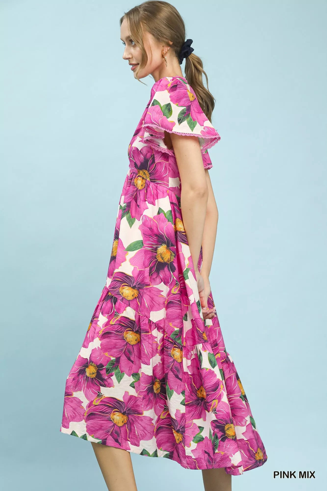 Pink floral tiered midi dress with V-neck and flutter sleeves by Umgee, perfect for tropical-inspired summer looks.
