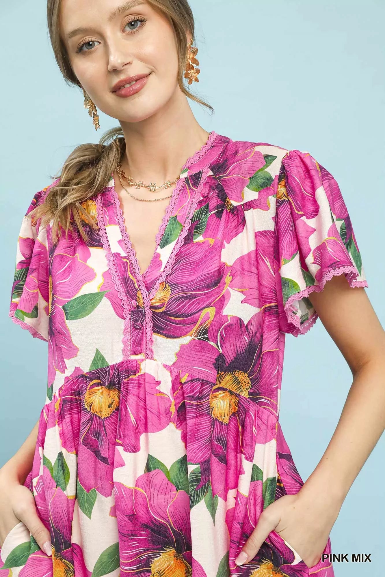 Pink floral V-neck midi dress with flutter sleeves and tiered design by Umgee for a stylish tropical look.