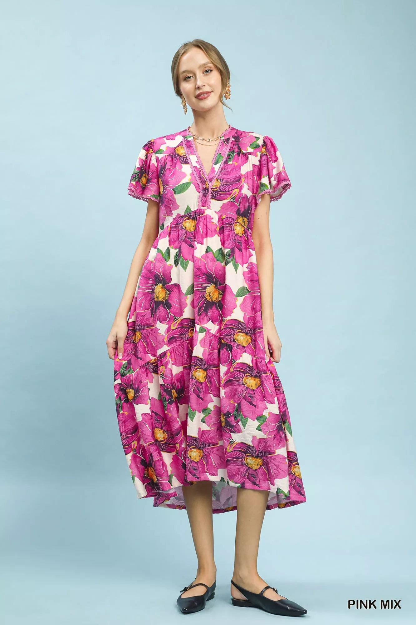 Pink floral tiered midi dress with V-neck and flutter sleeves by Umgee, featuring tropical print and relaxed fit.