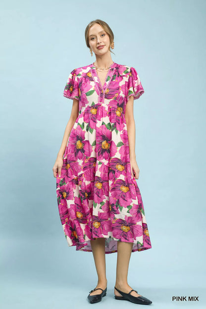 Pink floral tiered midi dress with V-neck and flutter sleeves by Umgee, featuring tropical print and relaxed fit.