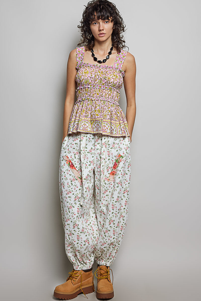 Pink printed smocked square neck peplum tank top with ruffle trim by Trendsi, featuring a stylish sleeveless design.