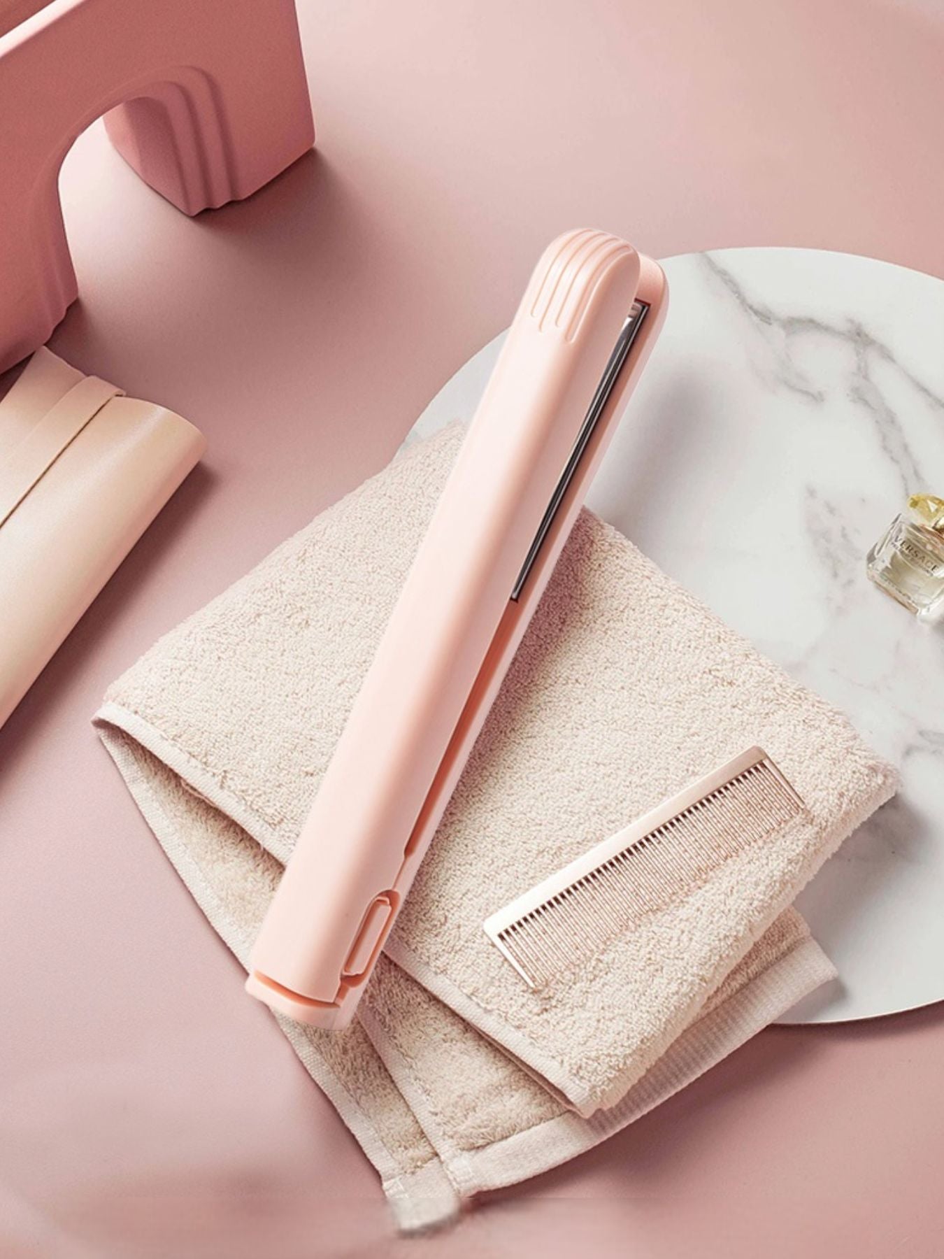 Pink portable cordless hair straightener by Trendsi, compact design with ceramic plates for easy styling on the go.