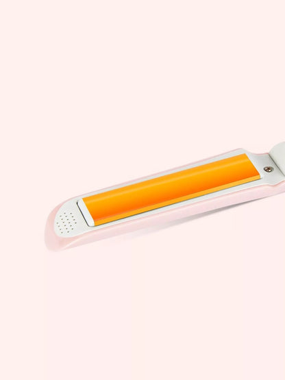 Pink portable hair straightener by Trendsi with a sleek design, ideal for quick styling on the go.