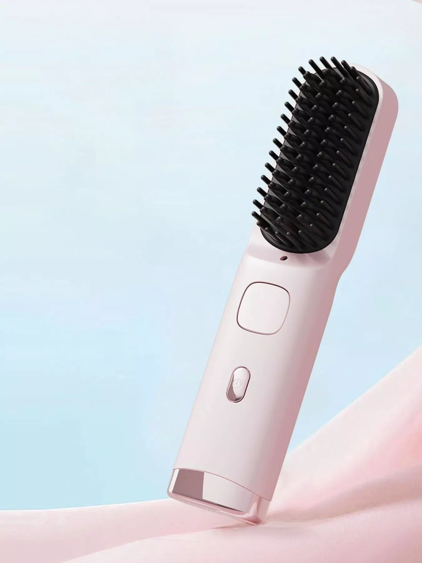Pink portable heated hair straightening comb by Trendsi, compact design for easy styling and hair smoothing.