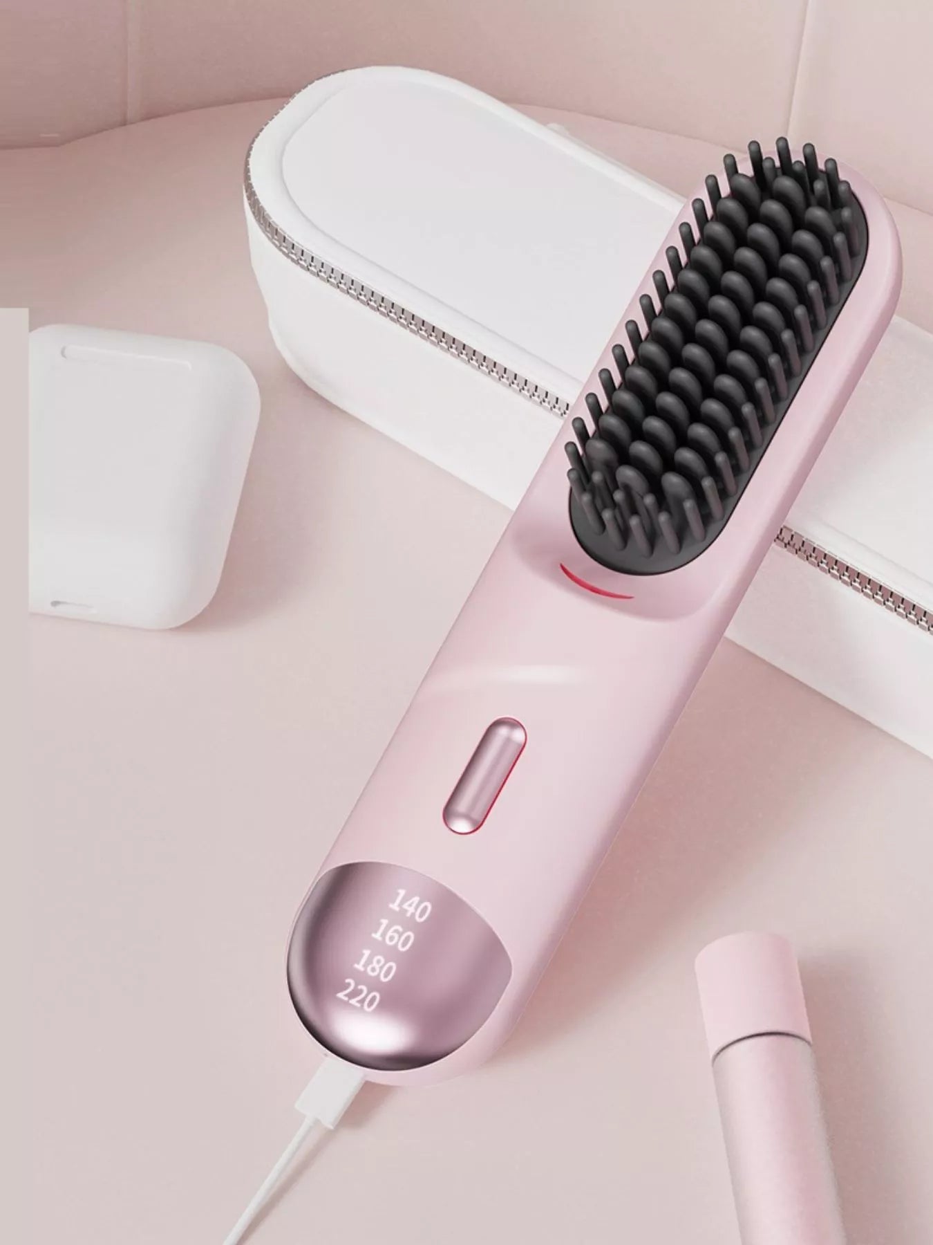 Pink portable heated straightening comb with adjustable temperature control, designed for easy hair styling on the go.