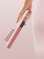 Pink rechargeable hair straightener by Trendsi, compact design with ceramic plates for smooth, sleek styling.