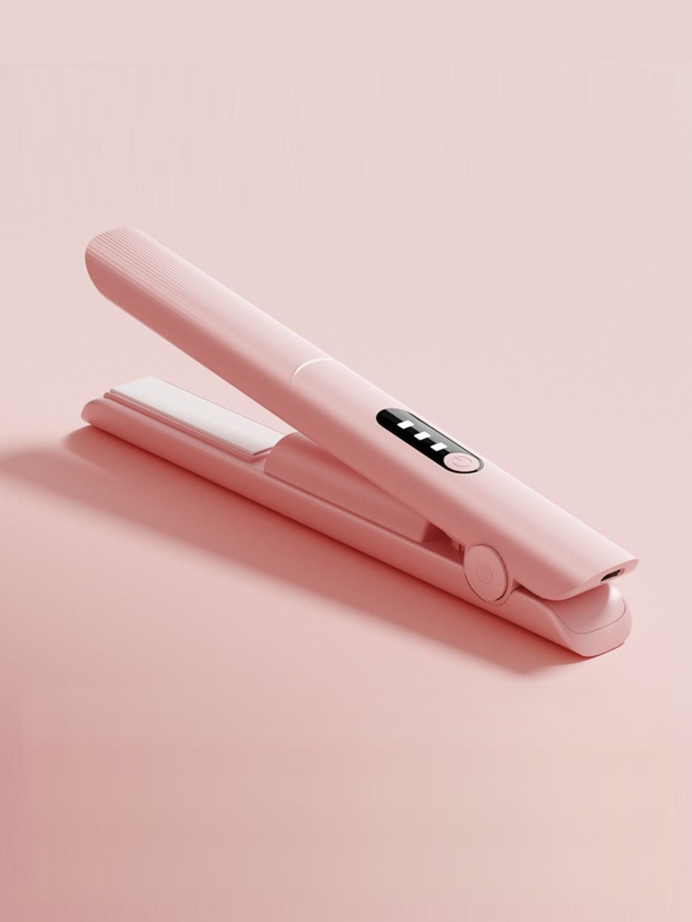 Pink rechargeable hair straightener from Trendsi with a sleek design, ideal for quick styling on the go.