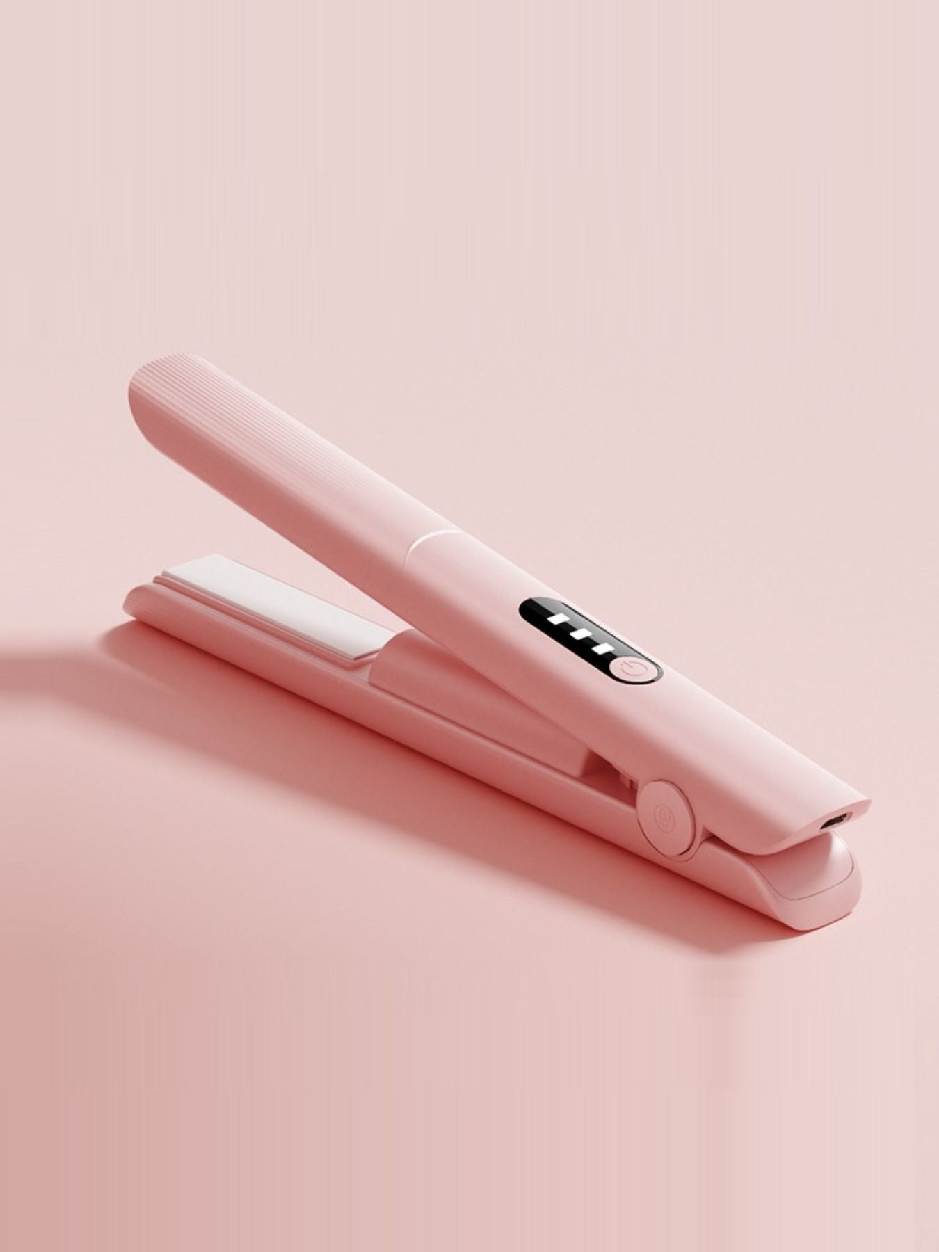 Pink rechargeable hair straightener from Trendsi with sleek design and compact size for easy styling on the go.