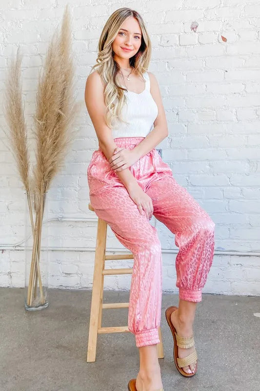 Pink satin leopard print joggers from Trendsi, featuring a relaxed fit and stylish animal print design.