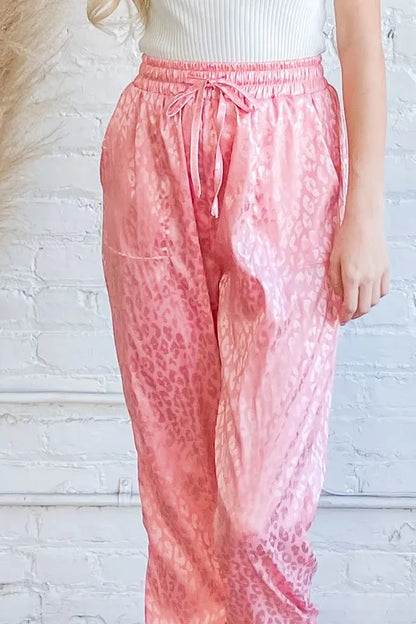Pink satin leopard print joggers from And The Why by Trendsi, featuring a stylish, relaxed fit and bold animal print design.