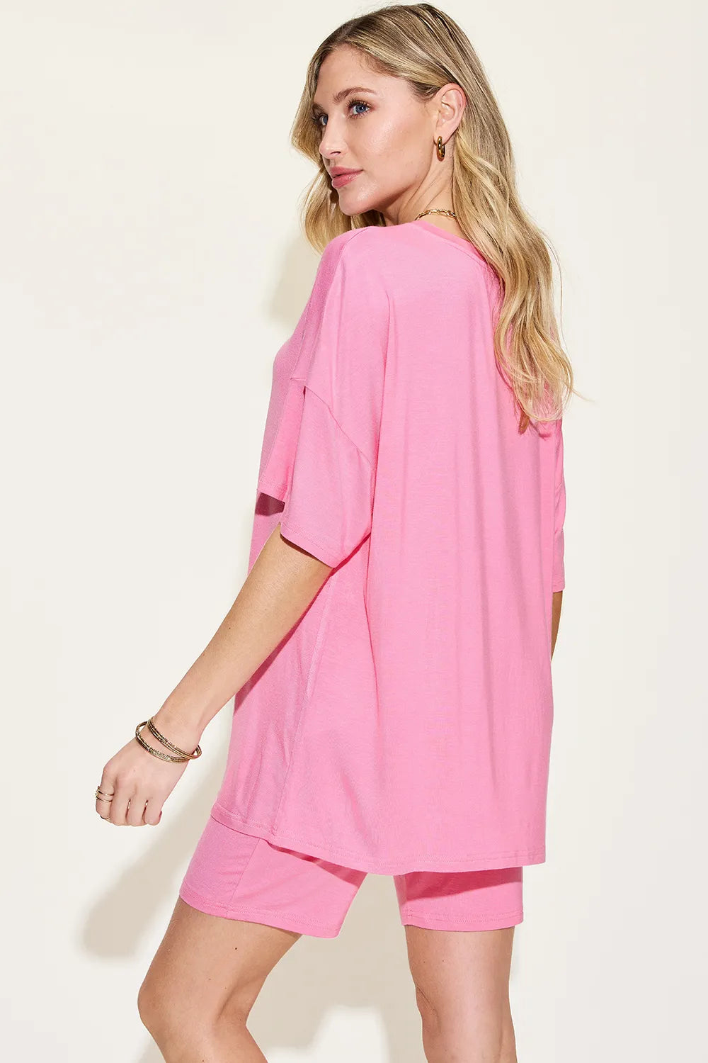 Pink Trendsi Basic Bae V-neck drop shoulder T-shirt and shorts set displayed on a hanger, casual and comfortable clothing ensemble.