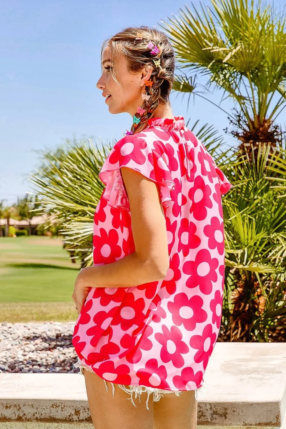 Pink BiBi Floral Contrast Ruffled Top by Trendsi with ruffled sleeves and floral pattern, styled on a mannequin.