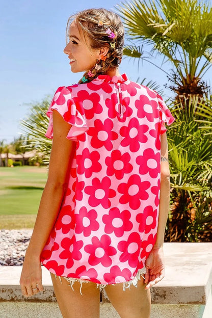 Pink BiBi Floral Contrast Ruffled Top by Trendsi featuring ruffled details and floral print on lightweight fabric.