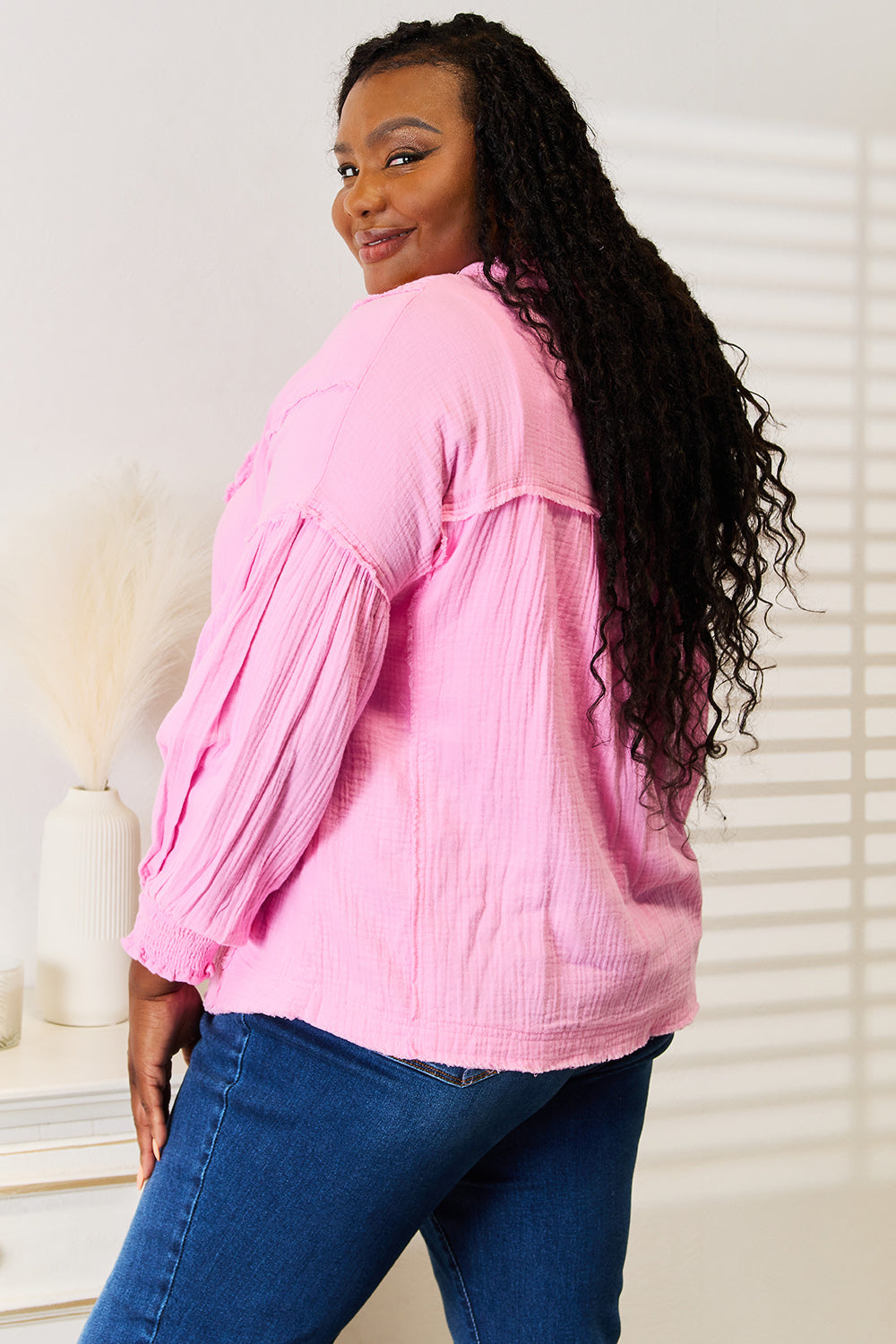 Pink double take blouse with exposed seams, button details, and notched neckline, by Trendsi.