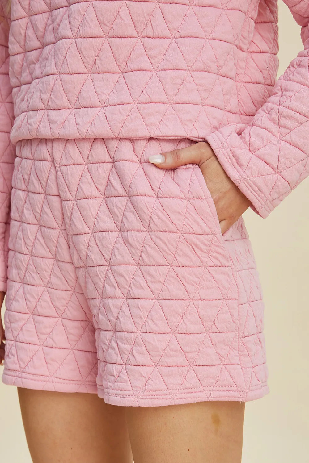 Pink textured long sleeve top and matching shorts set from Trendsi, featuring a round neck and casual style.