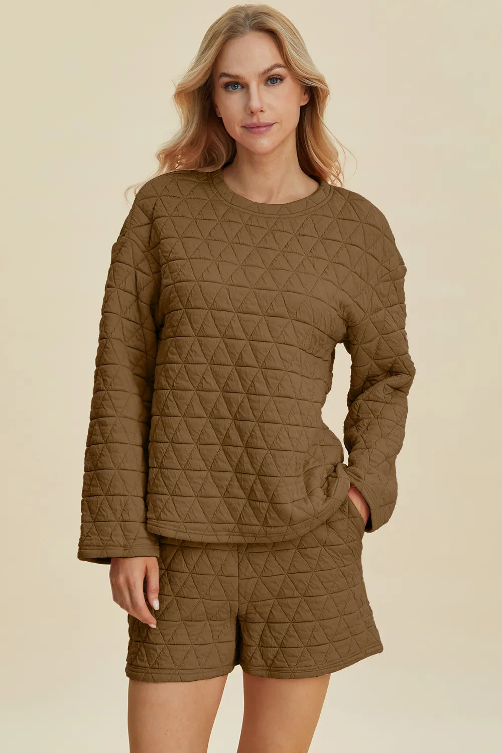 Pink textured round neck long sleeve top and matching shorts set from Trendsi, comfortable and stylish for casual wear.