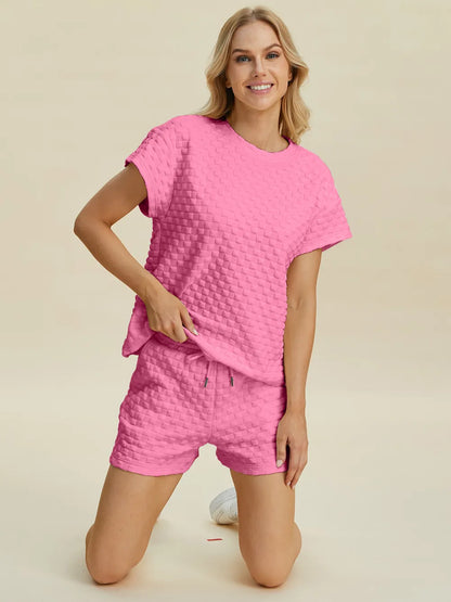 Pink double take full-size texture t-shirt and shorts set by Trendsi, featuring a casual fit and textured fabric design.