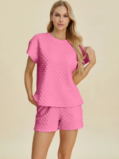 Pink double take full size texture t-shirt and shorts set by Trendsi, featuring a comfortable, stylish casual outfit.