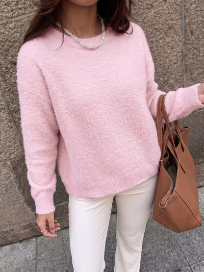 Pink fluffy long sleeve sweater by Trendsi, soft knit fabric with a cozy, relaxed fit, perfect for casual wear.