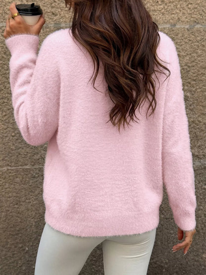 Pink fluffy long sleeve sweater from Trendsi featuring a cozy, soft knit fabric and a relaxed fit.