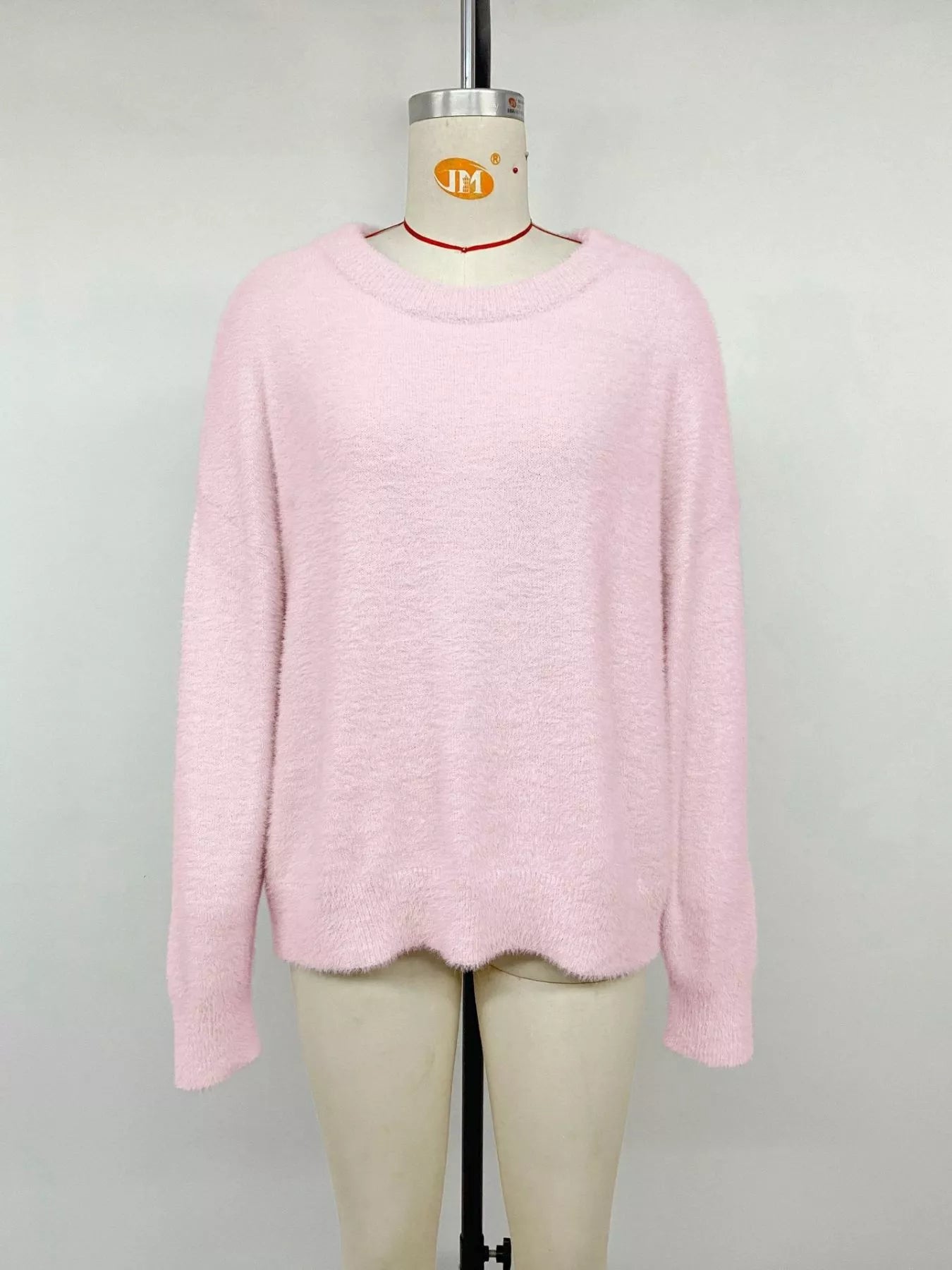 Pink fluffy long sleeve sweater from Trendsi, featuring a cozy, soft knit fabric and a relaxed fit.
