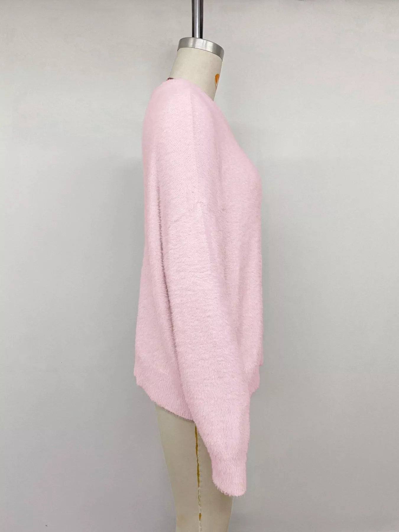 Pink fluffy long sleeve sweater from Trendsi, soft knit fabric with a cozy, relaxed fit and ribbed cuffs and hem.